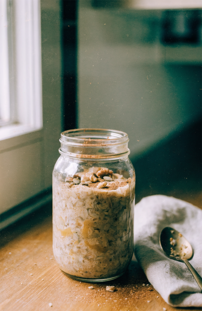 Creamy pumpkin pie overnight oats in a jar topped with pumpkin seeds and cinnamon